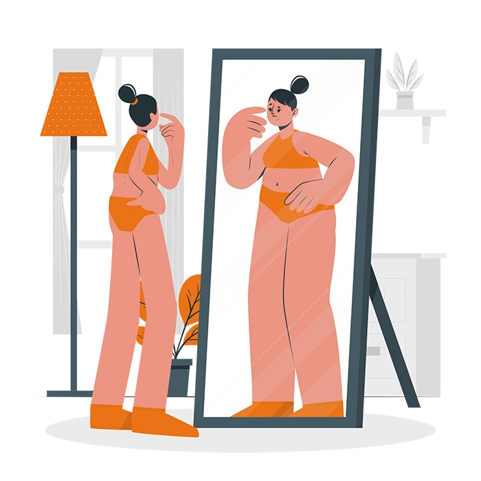 anorexia-nerviosa Una persona mira su reflejo en un espejo de cuerpo entero, donde ve una versión más grande de sí misma, una distorsión común que experimentan quienes luchan contra la anorexia nerviosa.